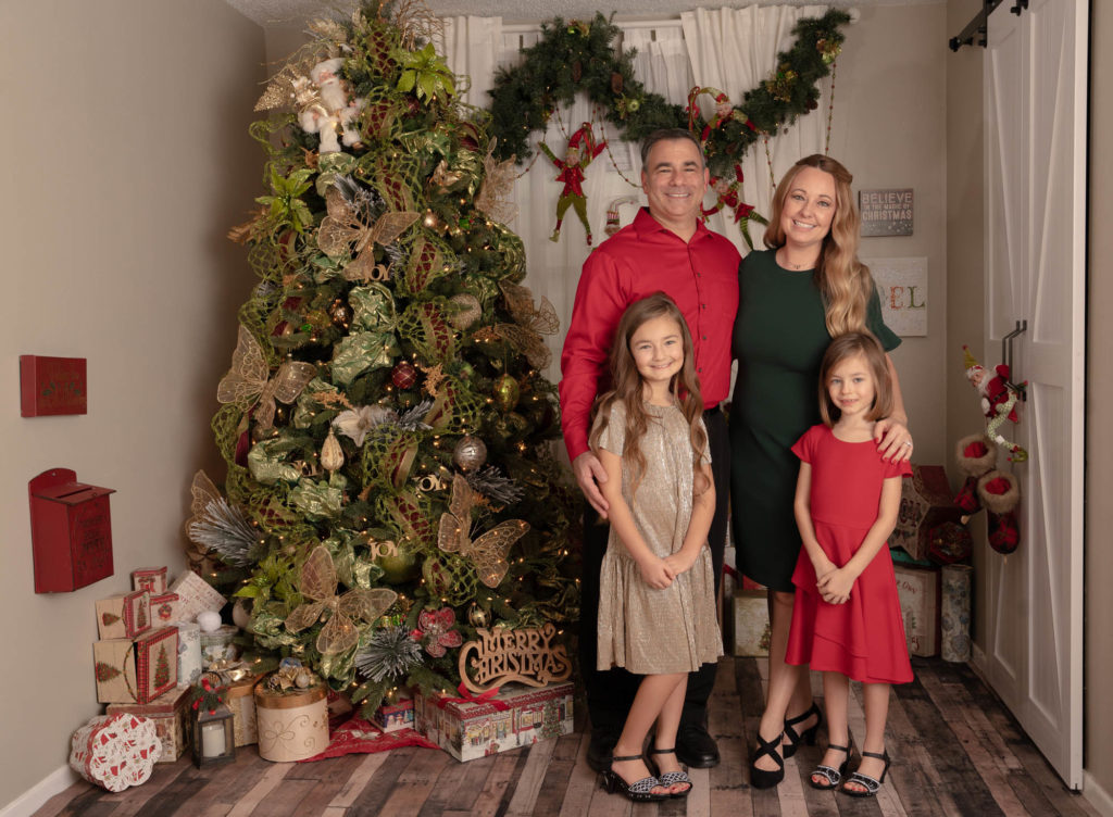 Family portrait with children next to a Christmas tree.  Winter Park FL