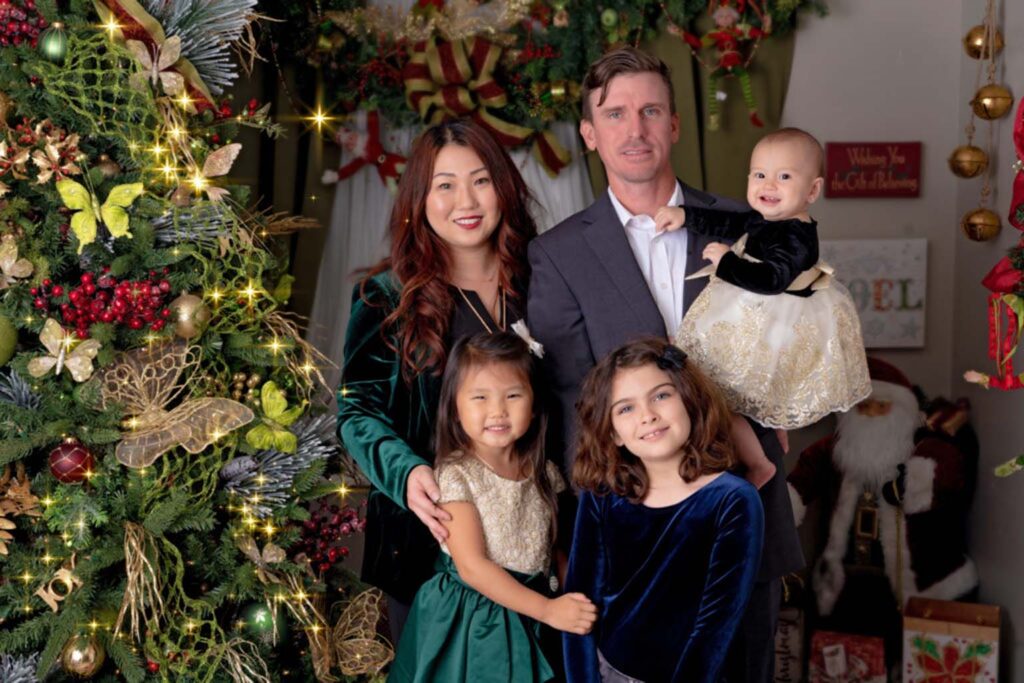 Christmas themed family portrait of a family in a christmas set
