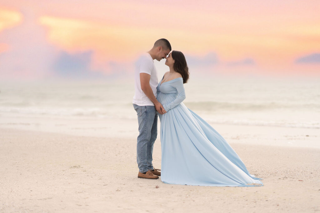 Outdoor couples maternity portrait with the sunset in the background