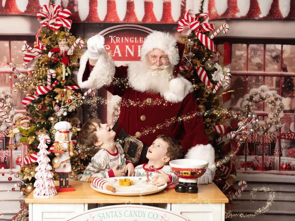 Children's christmas themed portraits of two kids sitting with Santa