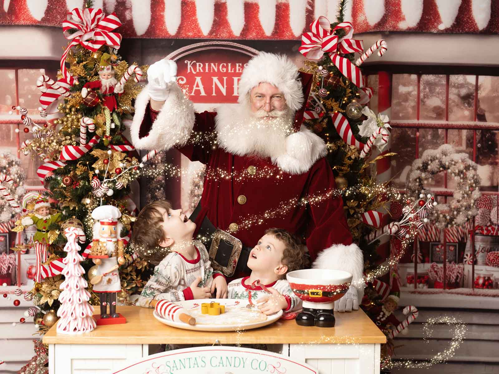 Children's christmas themed portraits of two kids sitting with Santa