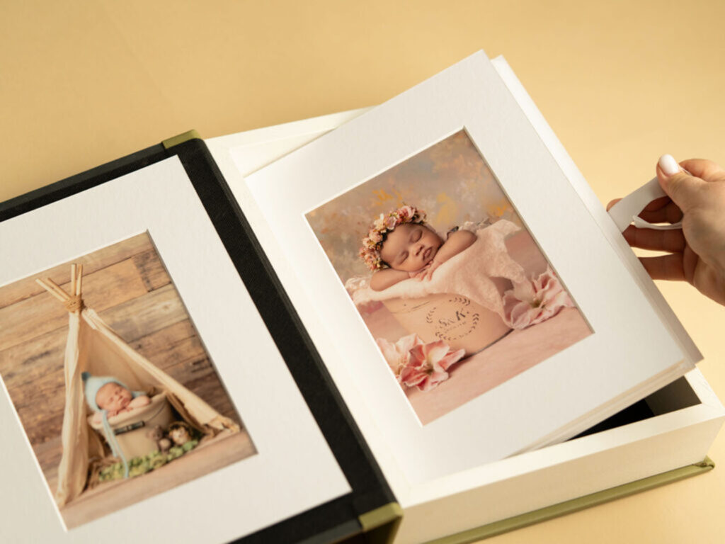 Image of a person lifting a print from a newborn portrait session
