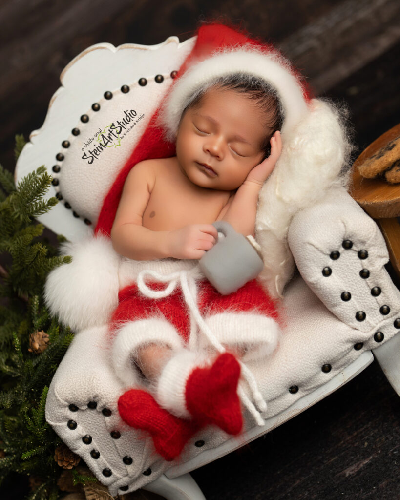 Luxury newborn photoshoot in Orlando featuring baby in red and gold Christmas theme