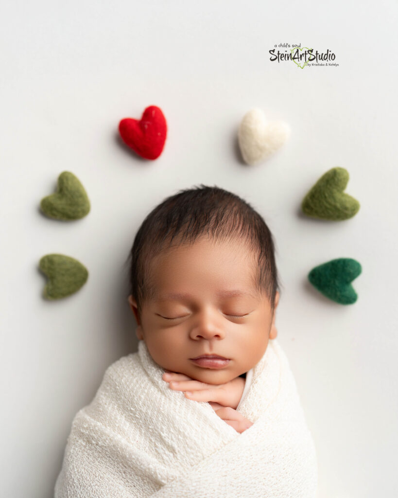 Luxury newborn photoshoot in Orlando featuring baby in red and gold Christmas theme